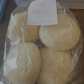 a bag contatining four soft dinner rolls